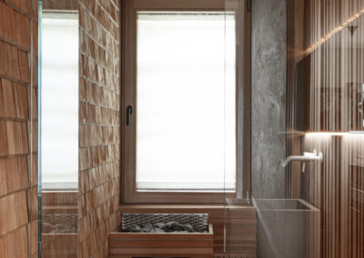 Dettaglio sauna in legno naturale, fotografia d’interni di montagna.