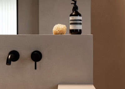 Bagno moderno con giochi di luce e colori neutri.